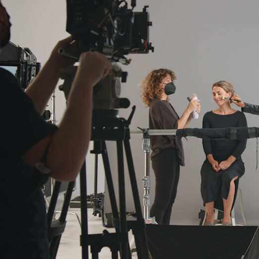 Actress getting hair done, camera in front